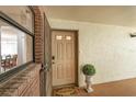 A welcoming front door with a welcome mat and decorative planter; glimpse of the interior dining area at 6188 80Th N St # 102, St Petersburg, FL 33709