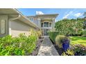 Contemporary home with a stylish entrance, highlighted by modern architecture, stone walkway, and artful landscaping at 6905 Pine Valley St, Bradenton, FL 34202