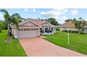 Attractive single-story home features a red tile roof, well-maintained landscaping, and an attached two-car garage at 7115 39Th E Ln, Sarasota, FL 34243