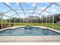 Screened-in pool and spa offer a relaxing oasis with lush greenery, perfect for outdoor enjoyment at 7115 39Th E Ln, Sarasota, FL 34243