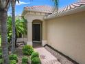 Inviting front entrance with a brick pathway and lush landscaping at 7130 Westhill Ct, Lakewood Ranch, FL 34202