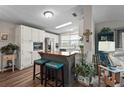 This eat-in kitchen has a center island with seating, white cabinetry, and stainless steel appliances at 8470 Imperial Cir, Palmetto, FL 34221