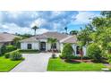 A manicured front yard and well-maintained landscaping create curb appeal for this lovely home at 1017 Tuscany Blvd, Venice, FL 34292
