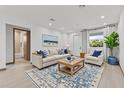 Bright living room with stylish decor, plush seating, and hardwood floors at 102 Arrow Ln, Rotonda West, FL 33947