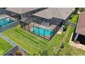 Aerial view of a screened-in backyard pool with ample green space and fencing providing a sense of privacy at 11223 Spring Gate Trl, Bradenton, FL 34211