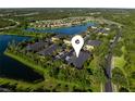 Aerial view of the community, highlighting the prime location near the water, lush landscaping, and ample parking at 13084 Tigers Eye Dr, Venice, FL 34292