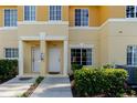 Up close view of the townhome's entrance, showing the individual unit numbers and well-kept landscaping at 13084 Tigers Eye Dr, Venice, FL 34292