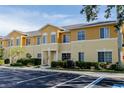 Eye-level exterior shot showcasing the facade with lush landscaping and parking at 13084 Tigers Eye Dr, Venice, FL 34292