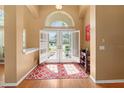 Inviting foyer with natural light, a decorative rug, and a view of the front yard through the open doors at 1508 86Th Nw Ct, Bradenton, FL 34209