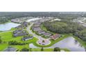 Aerial view of neighborhood shows homes on well-manicured lots with neighborhood ponds and mature tree growth at 16038 39Th E Gln, Parrish, FL 34219