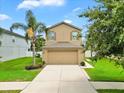 Well maintained two-story home with a two car garage and tropical landscaping at 2118 Song Sparrow Ct, Ruskin, FL 33570