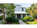 Charming two-story home features a well-manicured lawn and lush landscaping at 2410 Prospect St, Sarasota, FL 34239