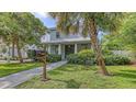 Charming two-story home features a well-manicured lawn and lush landscaping at 2410 Prospect St, Sarasota, FL 34239