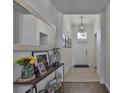 Welcoming foyer with tiled flooring, a decorative mirror, and an abundance of natural light at 2450 Dovesong Trace Dr, Ruskin, FL 33570