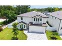 Aerial view of the house featuring a balcony, lush greenery and a well-manicured lawn at 2596 Floyd St, Sarasota, FL 34239