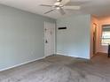 Bright living room with ceiling fan, neutral paint, and hallway to dining area at 3245 Beneva Rd # 203, Sarasota, FL 34232