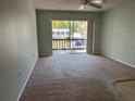 Spacious living room featuring sliding doors to a private balcony with a view at 3245 Beneva Rd # 203, Sarasota, FL 34232
