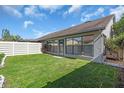 Fenced backyard with a well-maintained lawn and view of the home's exterior at 327 40Th W Ct, Palmetto, FL 34221