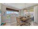 Bright dining area featuring a large window, wood table with seating, and view of the neighborhood at 4267 Expedition Way, Osprey, FL 34229
