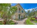 Beautiful two-story townhome with lush landscaping, brick sidewalks, and a private entrance at 4267 Expedition Way, Osprey, FL 34229