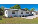 Well-maintained single-story home featuring fresh landscaping, a metal roof, and an attached garage at 4505 18Th W Ave, Bradenton, FL 34209