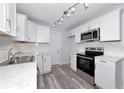 Modern kitchen with stainless steel appliances, white cabinets, and sleek countertops with modern lighting at 4505 18Th W Ave, Bradenton, FL 34209