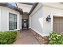A brick-paved path leads to the inviting front door of this beautifully landscaped home at 4735 Cassio Ct, Bradenton, FL 34211