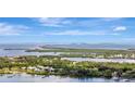 Scenic aerial view showcasing waterfront homes and a bridge over tranquil blue waters, ideal for coastal living at 4819 Palmetto Point Dr, Palmetto, FL 34221