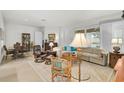 Bright and spacious living room featuring neutral tones and ample seating at 5662 Fossano Dr, Sarasota, FL 34238