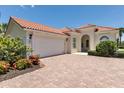 Charming single-story home with red tile roof, well-manicured landscaping, and a two-car garage at 5779 Wilena Pl, Sarasota, FL 34238