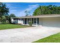 Home featuring a well-maintained lawn, long driveway, and attached two-car garage in a residential neighborhood at 616 59Th Nw St, Bradenton, FL 34209