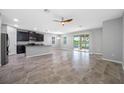 Open-concept living room with modern finishes, including granite countertops and lake views at 6550 Devesta Loop, Palmetto, FL 34221