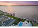 Breathtaking aerial view of waterfront property with private dock and a sparkling swimming pool at 676 Regatta Way, Bradenton, FL 34208