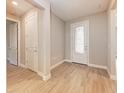 Bright foyer with neutral walls, tile floors, and a decorative glass-paneled front door at 7781 Grande Shores Dr, Sarasota, FL 34240