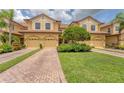 Beautiful townhomes with brick driveways and landscaping offer inviting curb appeal at 8261 Miramar Way # 8261, Lakewood Ranch, FL 34202