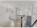 Upstairs hallway boasts sleek wood floors, natural light, and a modern aesthetic at 8261 Miramar Way # 8261, Lakewood Ranch, FL 34202