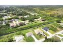 Scenic aerial view of homes nestled within a lush, green landscape at 8429 Malcolm Ave, North Port, FL 34287
