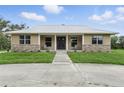 Charming home with stone accents, well-manicured lawn, and inviting covered front porch at 920 Lena Ln, Sarasota, FL 34240