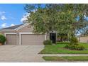 Charming home featuring a well-maintained lawn, an attached two-car garage and beautiful landscaping at 9927 58Th E St, Parrish, FL 34219