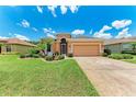 Charming home with a manicured lawn, decorative driveway, and mature landscaping at 12851 24Th Street E Cir, Parrish, FL 34219