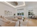 Bright and spacious living room with neutral decor, hardwood floors, and views of the backyard pool at 16511 Cornwall Ln, Lakewood Ranch, FL 34202