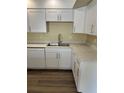 Bright kitchen with white cabinets, marble countertops, and modern stainless steel appliances at 201 Elliot Ave, Sarasota, FL 34232