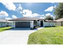 Charming single-story home boasts an attached garage, a well-maintained lawn and manicured landscaping at 234 Antofagasta St, Punta Gorda, FL 33983