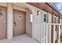 Close up view of a condo entrance with a unit number and door, highlighting the building's access point at 25100 Sandhill Blvd # V202, Punta Gorda, FL 33983