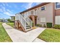 Exterior of the residence shows well-maintained lawn and sidewalk leading to the entrance of the building at 25100 Sandhill Blvd # V202, Punta Gorda, FL 33983