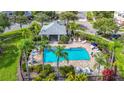 Community pool with a gazebo, plenty of seating and lush, tropical landscaping at 26548 Castleview Way, Wesley Chapel, FL 33544