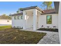 Inviting front entrance with modern lighting, neutral colors, and well maintained landscaping at 2813 Sally Ln, North Port, FL 34286