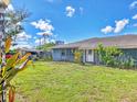Home exterior featuring shed and greenery with a lush green lawn at 2818 Olympic St, Sarasota, FL 34231