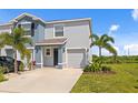 Two story townhome with a one car garage and a well manicured lawn with several trees at 2824 Pearly Banks Dr, Bradenton, FL 34208