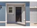 A close up exterior shot of the front door of this property with painted columns and a storm door at 2824 Pearly Banks Dr, Bradenton, FL 34208